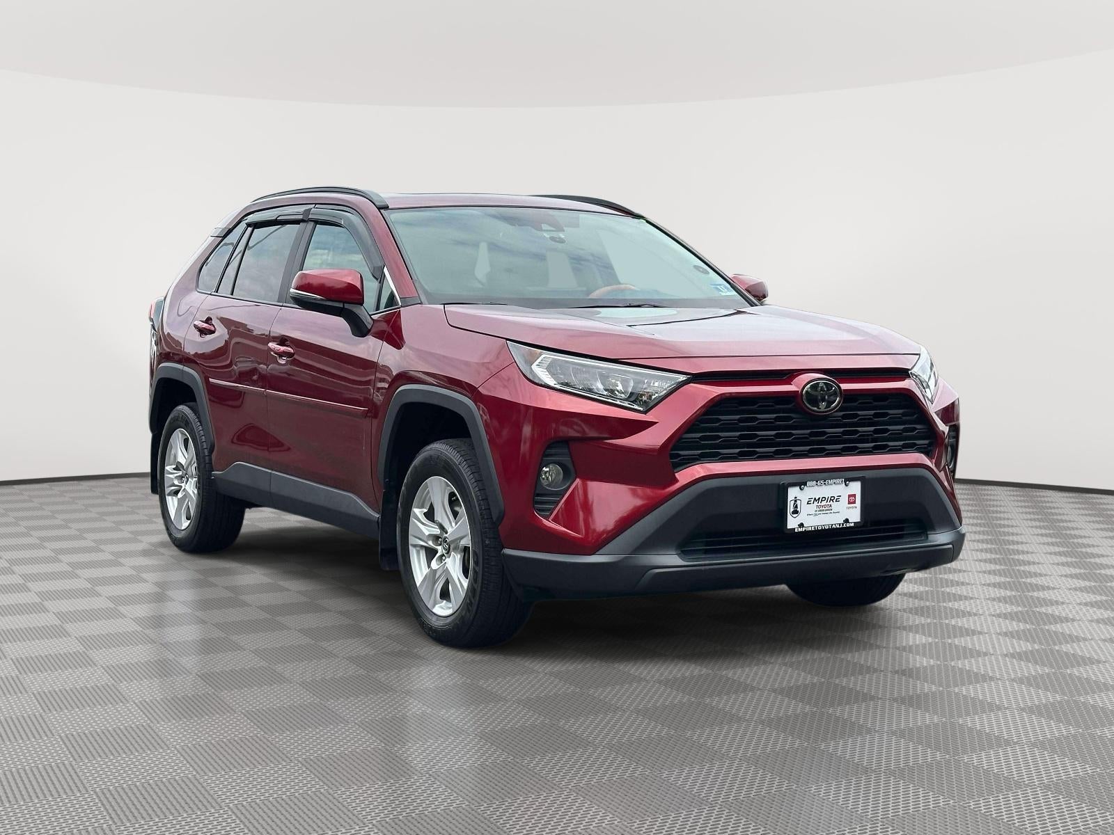 2020 Toyota RAV4 XLE in Ruby Flare Pearl — front three-quarter view