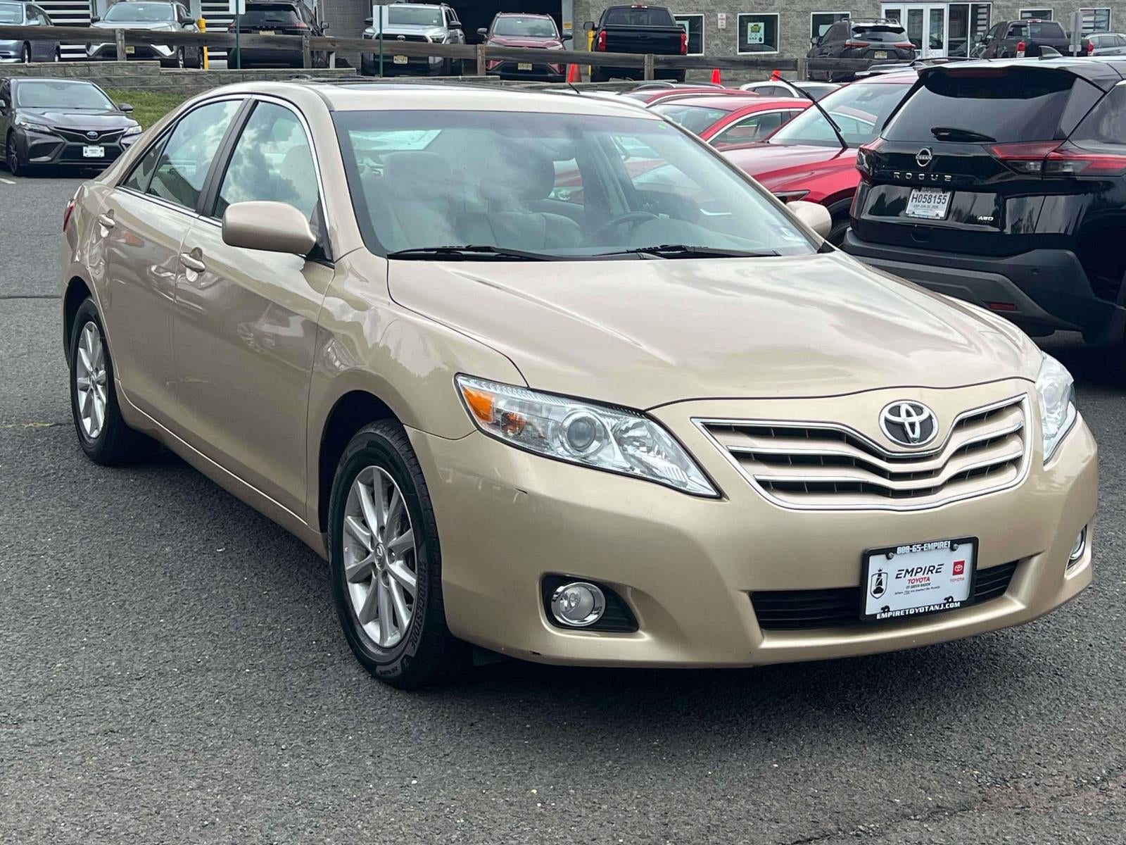 2010 Toyota Camry XLE in Gold — front three-quarter view