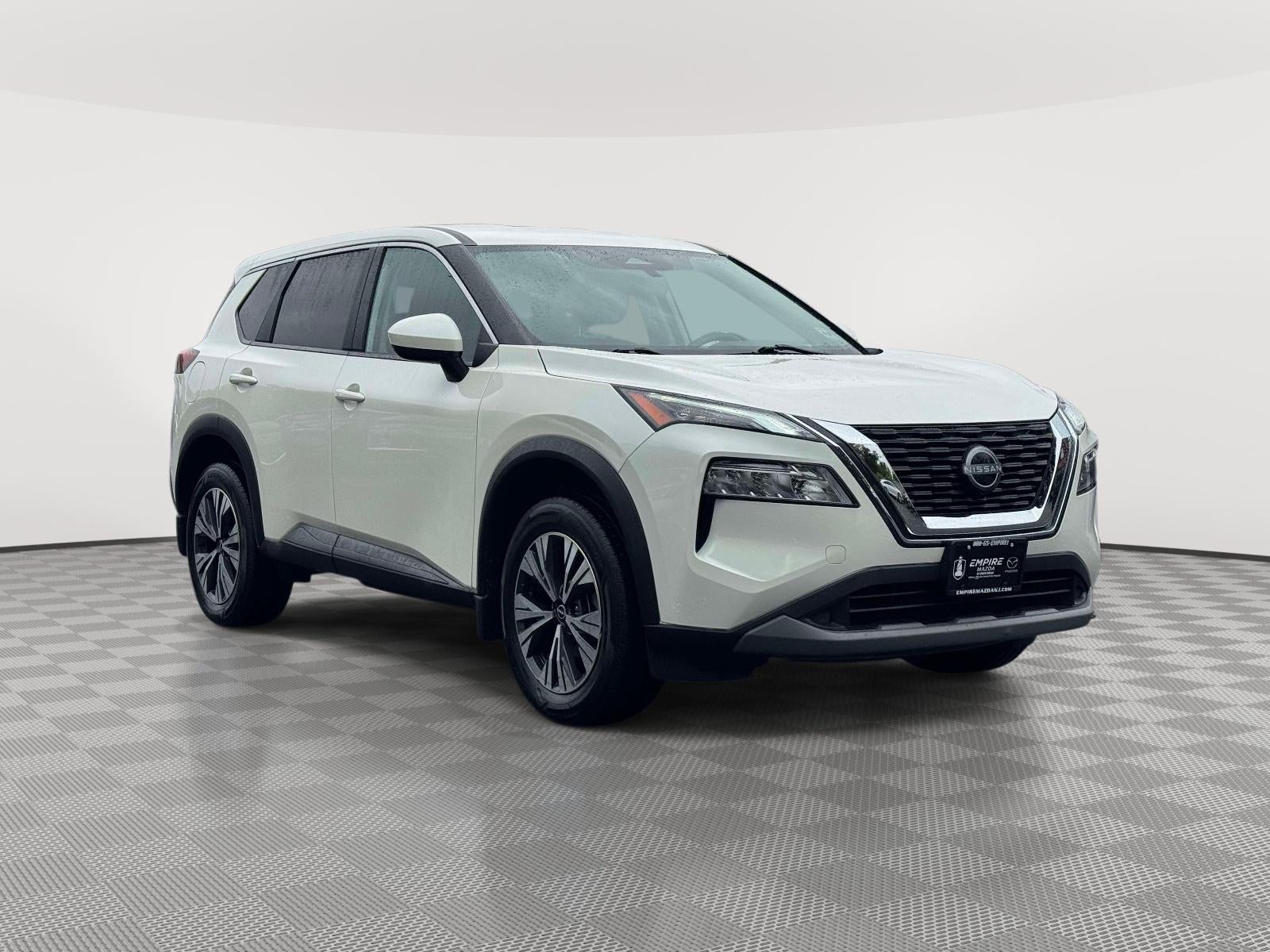 2023 Nissan Rogue SV Intelligent AWD in Pearl White Tricoat — front three-quarter view